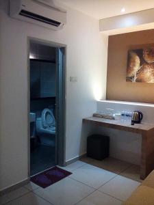 a room with a bathroom with a toilet in it at Rivero Boutique Hotel Melaka in Malacca