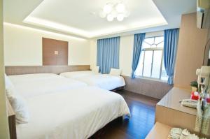 Ένα ή περισσότερα κρεβάτια σε δωμάτιο στο Kenting Jinjin Music Inn