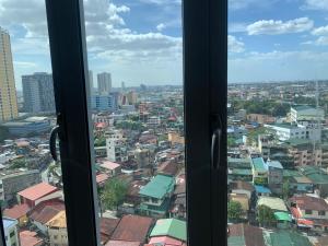 a view of a city from a window at The grass residences sm north edsa cozy comfortable heart of Quezon City in Manila