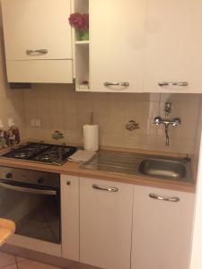 a kitchen with a sink and a stove top oven at Agriturismo Podere Campalto in Campiglia Marittima