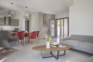 a living room with a couch and a table at Sun N Sea Kefalonia Villa in Kefallonia