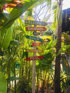 a street sign with many different signs on it at The Jungle House in Canggu
