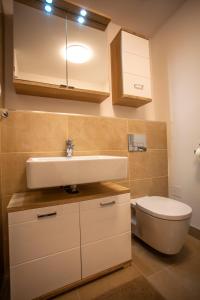 a bathroom with a sink and a toilet at Air-Conditioned City View Apartment 24h check-in in Bratislava +31 photos
