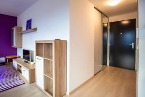 a room with a door to a room with a desk and a television at Air-Conditioned City View Apartment 24h check-in in Bratislava