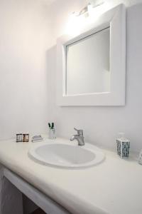 a bathroom with a white sink and a mirror at Super 2 in Super Paradise Beach