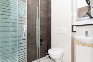 a bathroom with a toilet and a shower at Villa Solaris in Pobierowo +58 photos