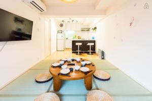 a living room with a wooden table and chairs at Tokyo Shibuya+1rooms+45m2+6pplmax+Best location+well designed in Tokyo