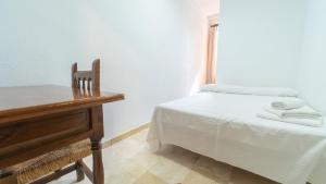 Postel nebo postele na pokoji v ubytování Hostal Bocanegra