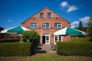 a brick building with two umbrellas in front of it at Ferienpark Mecklenburg in Ziegendorf