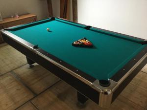 a pool table with a ball in a bowl on it at De Hocht in Nes