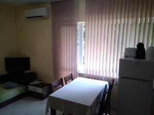 a room with a table and a white table and a window at Apartment Nedyalkov in Varna City
