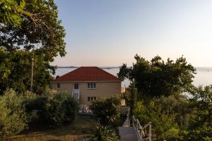 a house with a view of the ocean at Apartments Belenum in Mlini