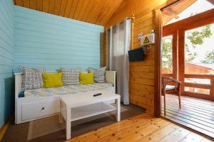 a room with a couch and a table on a porch at Complejo Rural Huerta Grande in Algeciras