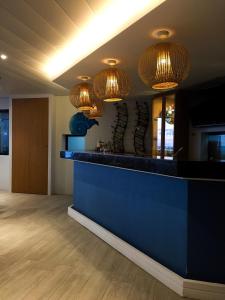 a lobby with a blue counter and chandeliers at 357 Boracay Resort in Boracay
