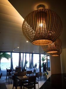 a restaurant with tables and chairs and a large chandelier at 357 Boracay Resort in Boracay
