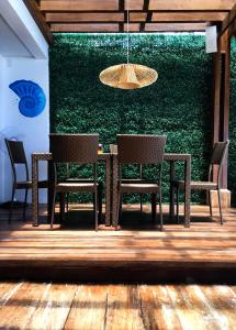 a table and chairs in front of a green wall at 357 Boracay Resort in Boracay