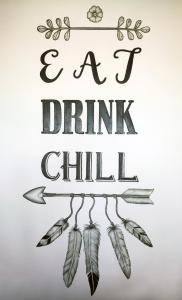 a sign that says eat drink chill with feathers at 357 Boracay Resort in Boracay