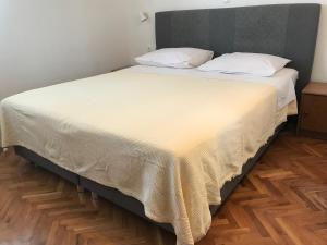 a large bed with a white blanket on it at Villa Lucia premium rooms in Primošten