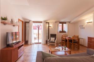 a living room with a couch and a table at Lets Holidays Heart of Tossa Apartment in Tossa de Mar