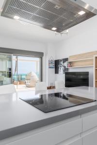 A kitchen or kitchenette at Luxury Beach Front Apartment with Pool