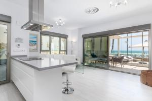 A kitchen or kitchenette at Luxury Beach Front Apartment with Pool