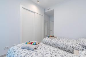 A bed or beds in a room at Luxury Beach Front Apartment with Pool