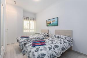 A bed or beds in a room at Luxury Beach Front Apartment with Pool