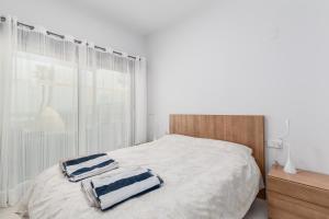 A bed or beds in a room at Luxury Beach Front Apartment with Pool