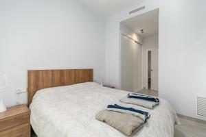 A bed or beds in a room at Luxury Beach Front Apartment with Pool
