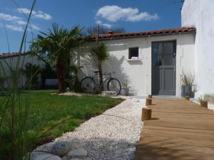 una casa con una bicicleta estacionada junto a una pasarela en Les Persiennes en Saintes