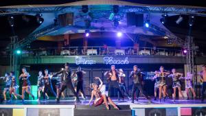 a group of people dancing on the stage at Pine Beach Belek in Belek