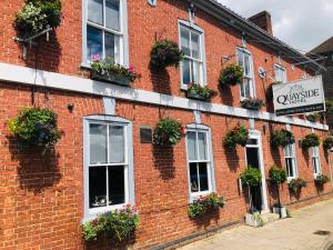 a red brick building with windows and flowerpots at Quayside Hotel & Bar in Boston