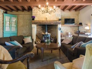 a living room with a couch and a fireplace at Magnificent holiday home with pool in Thenon in Thenon