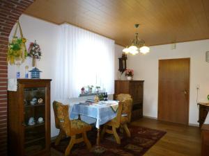a dining room with a table and chairs and a window at Apartment near the forest in Hullersen in Einbeck