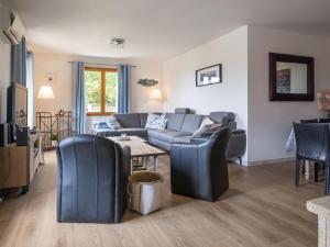 a living room with a couch and a table and chairs at Luxury villa with pool in Malvi s in Malviès