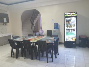 a kitchen with a table and chairs and a refrigerator at OMG Guesthouse Room for 6 in Licup