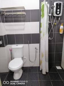 a bathroom with a toilet and a shower at alyaleesya homestay Teres in Brinchang