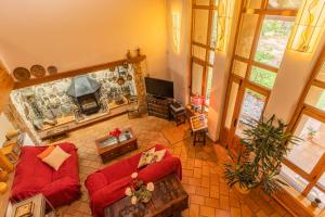 a living room with a red couch and a fireplace at Casa El Herragu in El Arenal