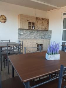 a dining room with two tables and a fireplace at Vila Yly in Eforie Nord