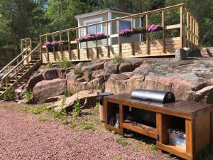 a house on top of a rock with a television on a table at Hortensia in Mariehamn