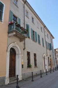 a large building with a balcony and a door at Antica Magnolia in Cherasco