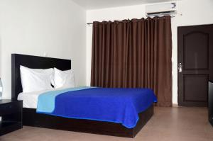 Ein Bett oder Betten in einem Zimmer der Unterkunft Riviera Taouyah Hotel