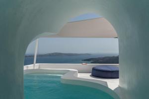 a plunge pool in a house with blue water at White Ark in Fira