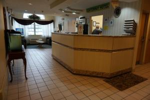 a man sitting at the counter of a restaurant at CenterWay Hotel Buffalo North Near University in Tonawanda