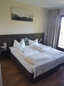 מיטה או מיטות בחדר ב-Weltmann`s Hotel & Restaurant