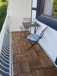 a patio with a table and a chair on a balcony at Weltmann`s Hotel & Restaurant in Ennepetal