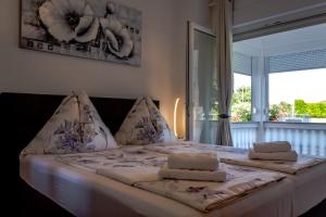 a bedroom with a bed with two towels on it at Kaja Apartments in Fažana