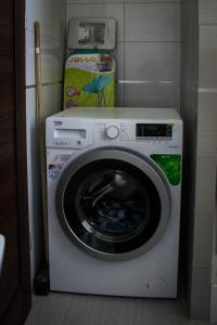 a washer and dryer in a corner of a room at Apartament 250m od morza! in Ustka