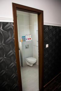 a bathroom with a toilet and a glass door at Apartament 250m od morza! in Ustka
