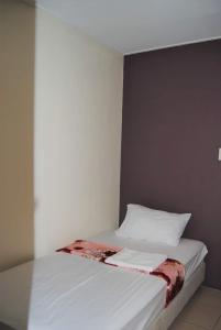 מיטה או מיטות בחדר ב-Cozy Inn Mactan